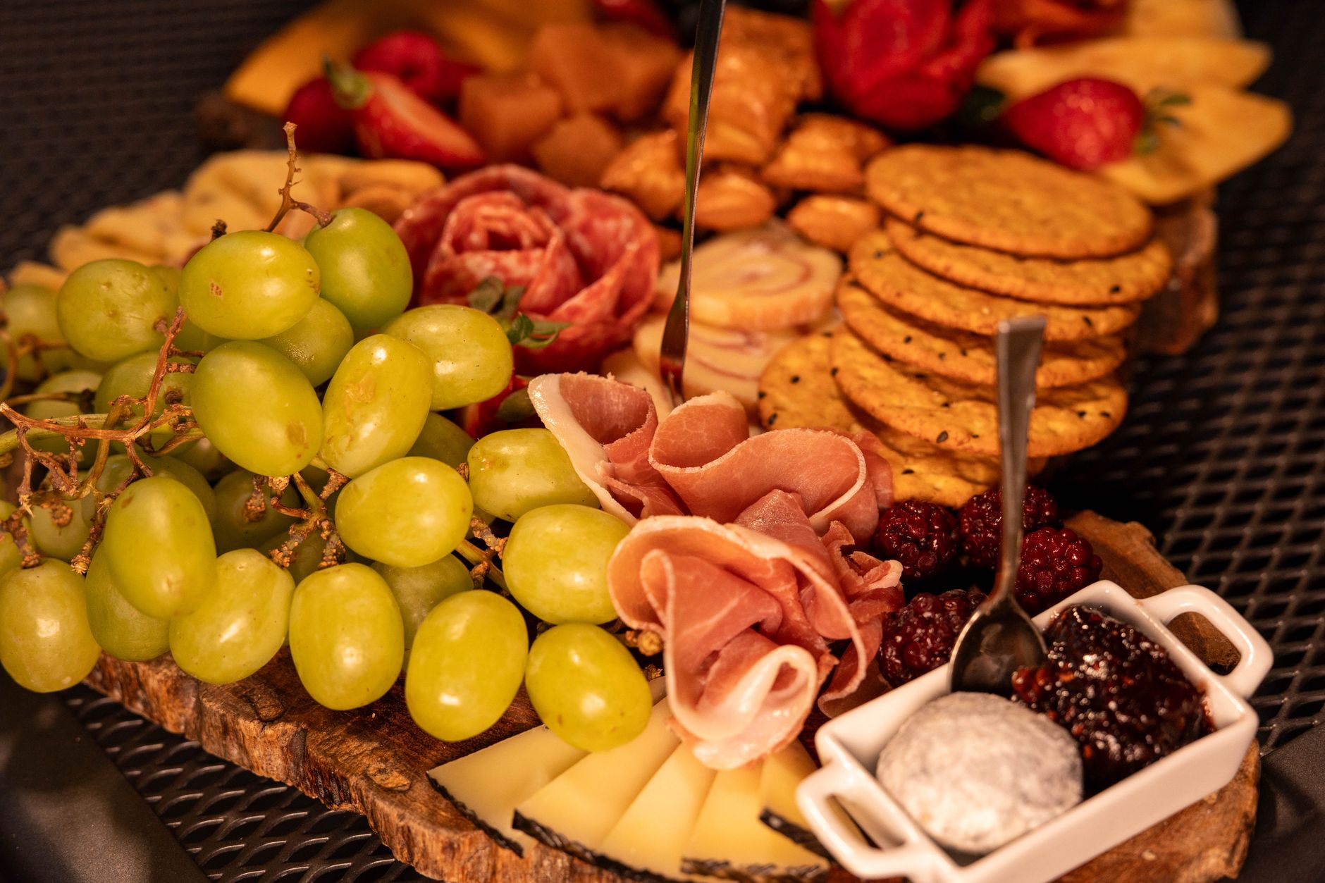 A loaded dip board with pita and veggies